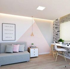 a living room filled with furniture and walls painted in different shades of pink, grey and white