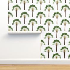 a wallpaper with green and white palm trees in the background on a wooden floor