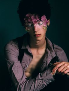 a woman with flowers on her face and hands