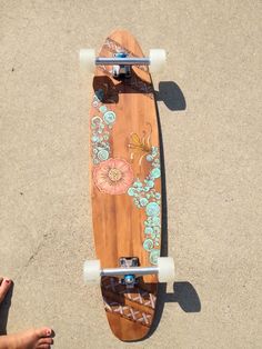 a person standing next to a skateboard with designs on the top and bottom wheels