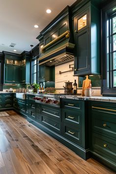 a kitchen with dark green cabinets and wood floors is pictured in this image, there are lights above the stove