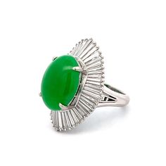 This captivating modern cocktail ring features a 7.86 carat oval cabochon cut jadeite as its centerpiece. The rich green jadeite is surrounded by a halo of fifty tapered baguette diamonds, totaling 2.61 carats. Each diamond, measuring 4.25 x 1.00 x .50 mm, is prong set to create a dazzling ballerina halo effect. The ring is crafted in platinum, which provides a sleek and sophisticated backdrop for the vivid jadeite and sparkling diamonds. The decorative under gallery adds an intricate touch of beauty to the piece. Whether for a glamorous event or just to bring brilliance to your day, this jadeite and diamond ring is a striking choice. GIA Certificate Number: 6224745601 Engagement Ring Style Guide, Ring Style Guide, Modern Cocktail, Halo Effect, Gia Certificate, Platinum Rose Gold, Diamond Cocktail Ring, Sapphire Solitaire, Baguette Diamonds