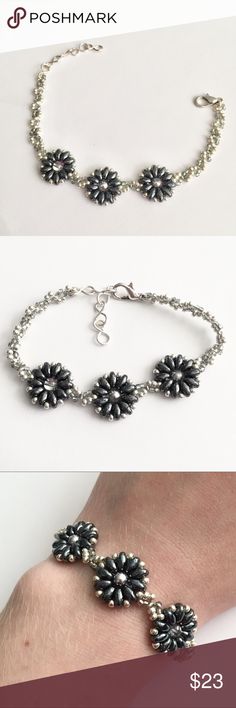 Handmade Hematite & Silver Beaded Bracelet An adorable beaded bracelet handmade with dark metallic superduo beads and two intertwined tones of seed beads. The dark gray and silver seed beads form a twist pattern between neutral colored flowers with silver glass centers. Adjustable from 7 to 8 inches. Item may vary slightly from the one shown. Not intended for children under 12. Jewelry Bracelets Hematite Beaded Bracelets With Faceted Beads, Hematite Beaded Bracelet With Silver Beads, Silver Hematite Beaded Bracelets With Black Beads, Handmade Bohemian Hematite Beaded Bracelets, Bohemian Handmade Hematite Beaded Bracelets, Adjustable Silver Beaded Necklaces With Bead Caps, Handmade Hematite Beaded Bracelets, Silver Beaded Bracelets With Black Round Beads, Beaded Hematite Bracelets For Jewelry Making