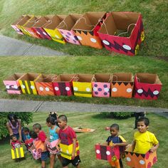 several children are standing in front of cardboard boxes that look like they're going to play with each other