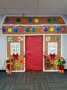 a gingerbread house decorated for christmas with candy and candies on the front door