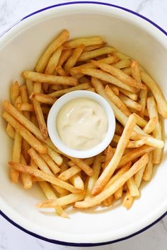 french fries in a white bowl with a dipping sauce