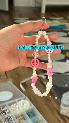 a hand holding a phone charm with the words how to make a phone charm?