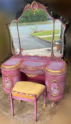 a pink vanity with mirror and stool in front of the window, next to a driveway