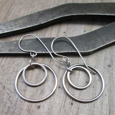 I have been having fun with stainless steel earrings lately and here is another pair. These are 1.5" in total length and have a titanium ear wire. These are completely hypoallergenic earrings. The circle shaped connectors are perfect for a minimalist look. These will not tarnish or change over time. The largest circle link is 20mm in size, the small one is 12mm. These are smooth and exactly the same front and back. The jump rings are also stainless steel.  If you love the look but would prefer longer, please reach out to me about availability and what you would like. I am happy to make something perfect for you. To find all the stainless steel options in my shop start here, https://www.etsy.com/shop/CraftLikeAnArtist?search_query=stainless+steel Simple Circle Nickel-free Earrings, Cadmium-free Round Earrings For Everyday, Minimalist Cadmium-free Sterling Silver Earrings, Adjustable Stainless Steel Hoop Earrings, Nickel-free Minimalist Surgical Steel Earrings, Minimalist Surgical Steel Hoop Earrings Gift, Simple Round Hypoallergenic Earrings, Hypoallergenic Round Surgical Steel Earrings, Minimalist Surgical Steel Jewelry For Everyday