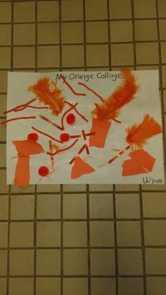 an orange collage is on the floor next to a white sign that says, my orange collage