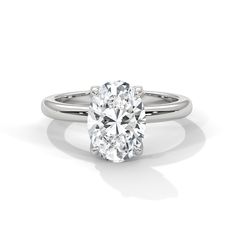 The Tulip Setting, a mesmerizing solitaire ring that combines elegance with intricate detail. This setting features diamond-adorned petal prongs underneath the center stone, adding a subtle yet dazzling touch to the ring. Each diamond on the prongs enhances the brilliance and beauty of the central diamond, creating a floral-inspired design that captures attention from every angle. Perfect for those who appreciate fine craftsmanship and unique embellishments, The Tulip Setting is a symbol of refi Refined Moissanite Solitaire Jewelry, Refined Oval Diamond Cut Ring, Refined Oval Cut Diamond Ring, White Solitaire Ring In Fine Jewelry, Oval Lab Grown Diamond Ring For Formal Occasions, White Solitaire Ring In Fine Jewelry Style, Fine Jewelry Solitaire Diamond Ring, White Gold Oval Ring With Lab Grown Diamond, Oval White Gold Ring With Lab Grown Diamond