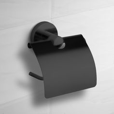 a black toilet paper holder on the wall