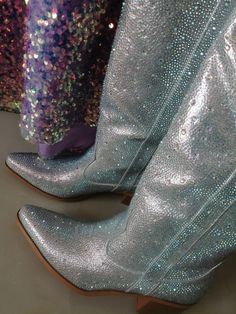 Step into the spotlight with these dazzling rhinestone-embellished cowboy boots, designed to make a statement wherever you go. Featuring a shimmering exterior covered in meticulously placed rhinestones, these boots bring a sparkling twist to the classic Western silhouette. The pointed toe and stacked low heel add both elegance and comfort, making them perfect for both day and night wear. Crafted with a durable sole and cushioned insole, these boots provide all-day comfort while maintaining a chi Western Silhouette, Rhinestone Boots, Ruffle Skirts, Floral Heels, Floral Sandals, Girls Heels, Glitter Heels, Rhinestone Heels, Bow Heels