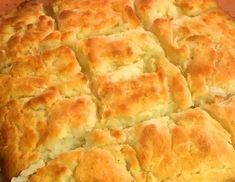 a casserole dish filled with cheese and biscuits