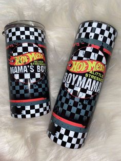 two black and white canisters with hot wheels on them