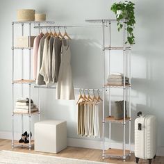 an iron rack with clothes and shoes on it