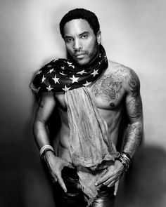 a shirtless man with an american flag scarf around his neck and hands on his hips