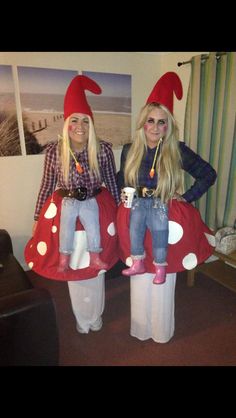 two women dressed in costumes standing next to each other