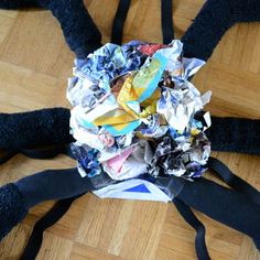 a bunch of trash sitting on top of a wooden floor next to a black ribbon