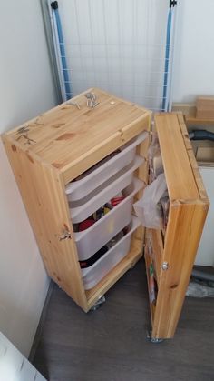 an open cabinet in the corner of a room