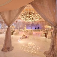 the inside of a wedding reception with chandeliers