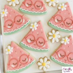 decorated cookies in the shape of slices of watermelon with sunglasses and daisies