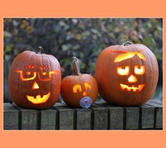 three pumpkins with faces carved into them