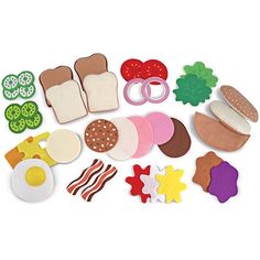 an assortment of felt food items displayed on a white surface