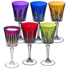 six different colored wine glasses sitting next to each other