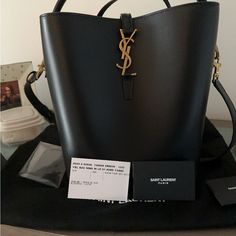 Brand New -Ysl Bucket Bag. Never Used -With Zipper Pouch Designer Bucket Bag With Branded Hardware, Modern Rectangular Bucket Bag With Branded Hardware, Modern Evening Bucket Bag With Branded Hardware, High-end Evening Bucket Shoulder Bag, High-end Evening Bucket Bag, Luxury Black Bucket Bag With Branded Hardware, Modern Black Bucket Bag With Branded Hardware, Black Everyday Luxury Bucket Shoulder Bag, Luxury Bucket Bag With Branded Hardware In Tote Shape