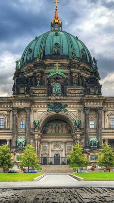 a large building with a green dome on top