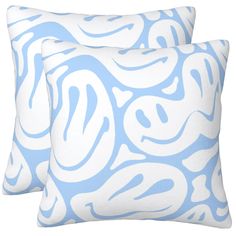 two blue and white pillows with swirl designs on them, one in the shape of a wave