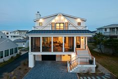 a large white house with stairs leading up to it