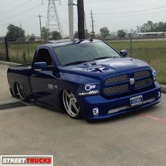 a blue truck parked in a parking lot