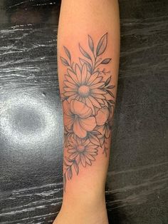 a woman's leg with a flower tattoo on it