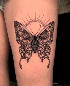 a woman's thigh with a butterfly tattoo on it