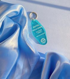 a blue satin fabric with a keychain attached to it