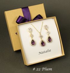 "Purple Plum bridesmaid bracelet earrings Plum bridal jewelry set Bridesmaid necklace earring set Dark Purple wedding jewelry set Purple plum This set has top clear AAA cubic zirconia posts matched with middle round clear CZ charms and bottom Plum purple (color no. 22) pendants. They are in Rose gold, Gold and White gold (silver colored) plated settings, nickel and lead safe, and are tarnish resistant. Different stone colors are available (see color chart in last picture), please leave a note for color number in the \"add a note to seller\" box at checkout if you prefer a different stone color. Default will be plum stone pendant (no. 22) as pictures show.  Matching bracelet with plum and clear CZ stones, other colors and patterns are also available at your request (see last picture for col Crystal Jewelry Sets For Gifts, Crystal Jewelry With Matching Earrings For Gifts, Purple Cubic Zirconia Jewelry Sets For Gift, Purple Cubic Zirconia Jewelry Sets As Gift, Purple Crystal Jewelry Sets For Wedding, Purple Crystal Jewelry For Gift, Cubic Zirconia Dangle Bridal Necklace For Gift, Elegant Purple Jewelry Set With Matching Earrings, Cubic Zirconia Dangle Bridal Necklace