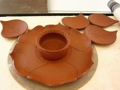 a clay bowl sitting on top of a plate