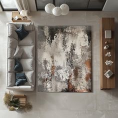 an aerial view of a living room with white couches and paintings on the wall