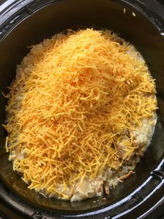 the food is being cooked in the crockpot with cheese on top, and ready to be put into the slow cooker