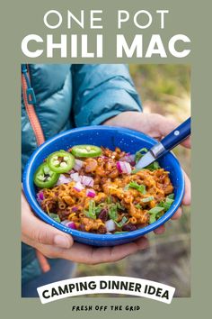 a person holding a blue bowl filled with food