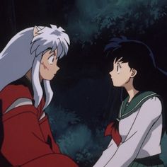 two anime characters are facing each other in front of trees and bushes, one is looking at the other