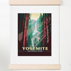 the yosemite national park poster is hanging on a wall