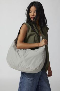 Large version of BAGGU’s Nylon Crescent Bag, effortlessly casual and large enough to carry more than just the essentials. With an adjustable tonal logo strap, it wears comfortably across the body or on the shoulder for a hands-free experience. Complete with two interior pockets that make it easy to stay organized. Made of recycled heavyweight nylon with a recycled ripstop lining. Features Larger version of our fave BAGGU crescent bag Roomy enough to fit a laptop & your essentials Made with recyc Baggu Crescent Bag, Baggu Crescent, Baggu Leather, Circle Purse, Baggu Bags, Duck Bag, Crescent Bag, Leather Tote Bag Women, Mercer Island