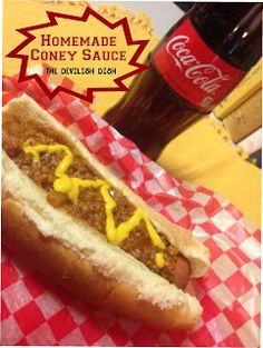 a hot dog with mustard and ketchup sitting on top of a checkered table cloth