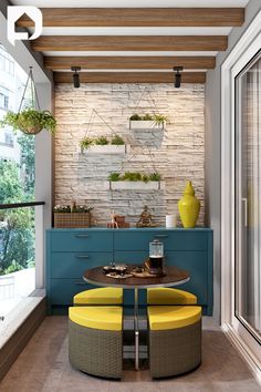 a dining room table with two yellow chairs and a blue cabinet in the corner next to it