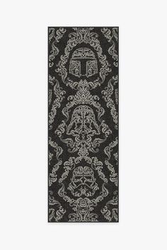 a black and white rug with an ornate design