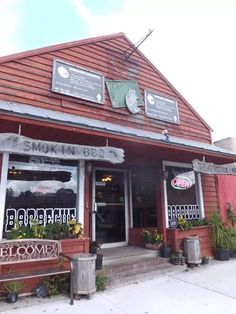 the outside of a restaurant with red siding