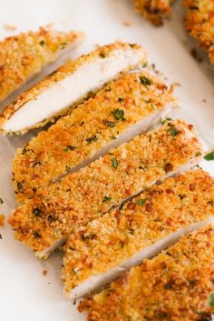 sliced chicken with parmesan and herbs on it